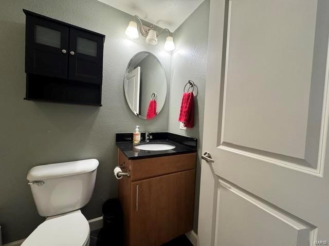 half bathroom with toilet and vanity