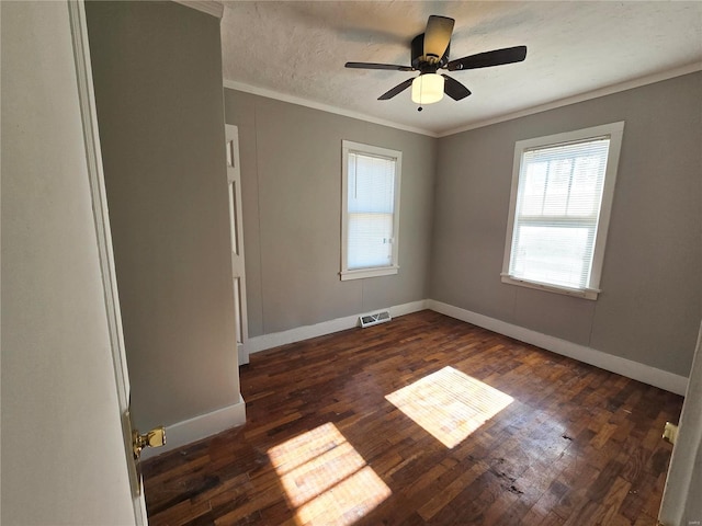 unfurnished room featuring ornamental molding, dark wood-type flooring, baseboards, and ceiling fan