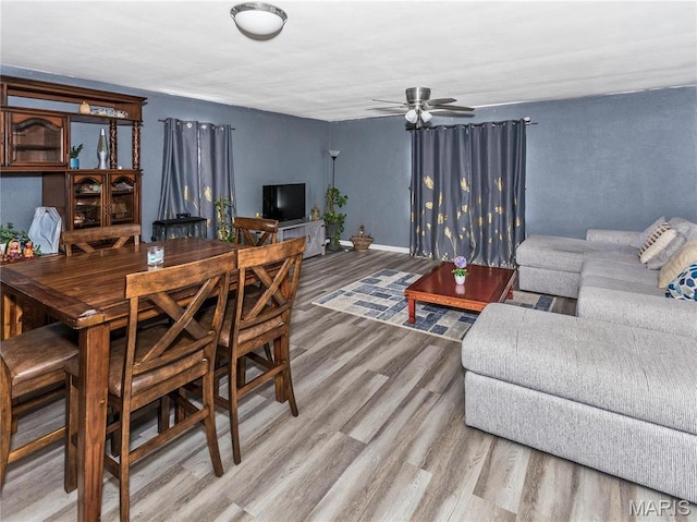 514 Penn St, Belleville, IL 62223 - dining room with light wood-style flooring, a ceiling fan, and baseboards