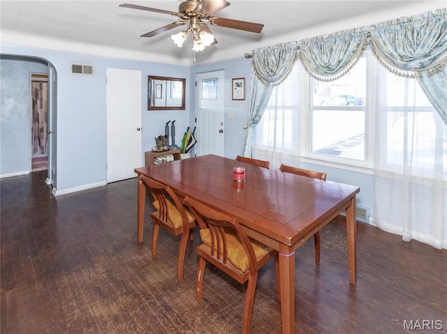 514 Penn St, Belleville, IL 62223 - dining area featuring wood finished floors, a ceiling fan, baseboards, and arched walkways