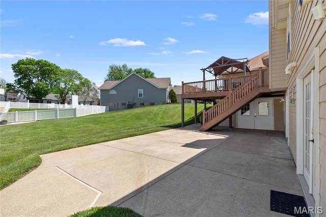 view of patio / terrace with a wooden deck, a residential view, and stairs