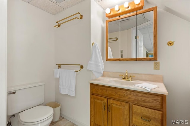 half bathroom featuring toilet, vanity, and tile patterned flooring