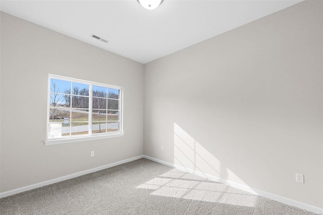carpeted empty room with baseboards