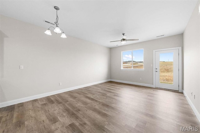 887 Walter Way, Washington, MO 63090 - empty room with wood finished floors, ceiling fan, a chandelier, and baseboards