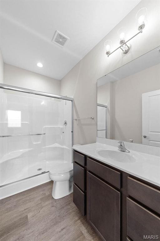 887 Walter Way, Washington, MO 63090 - bathroom with toilet, wood finished floors, vanity, and a shower