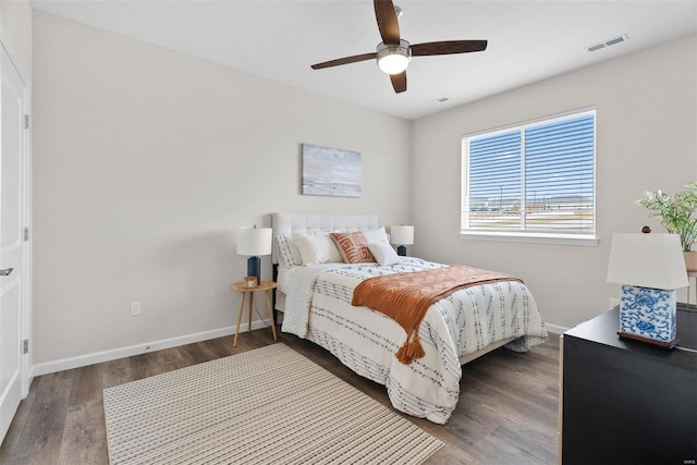bedroom featuring wood finished floors, baseboards, and ceiling fan