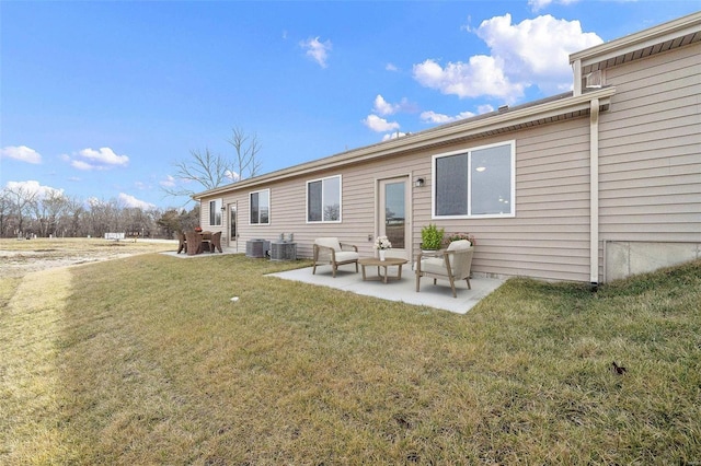 back of property featuring a patio area, cooling unit, and a yard