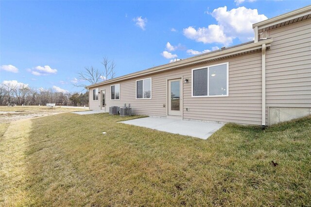 back of house with a patio, a yard, and central AC unit
