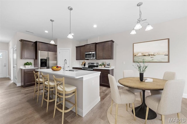 883 Walter Way, Washington, MO 63090 - kitchen featuring appliances with stainless steel finishes, light wood finished floors, a sink, baseboards, and recessed lighting