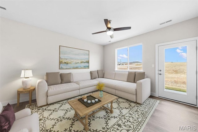 883 Walter Way, Washington, MO 63090 - living area with wood finished floors, baseboards, and a ceiling fan
