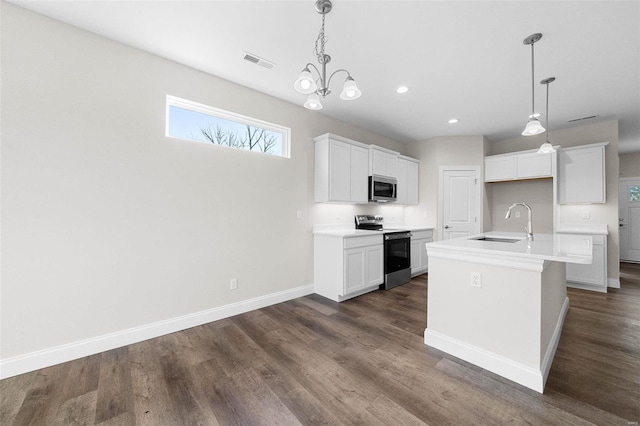 kitchen featuring range with electric cooktop, stainless steel microwave, a sink, dark wood-style floors, and recessed lighting