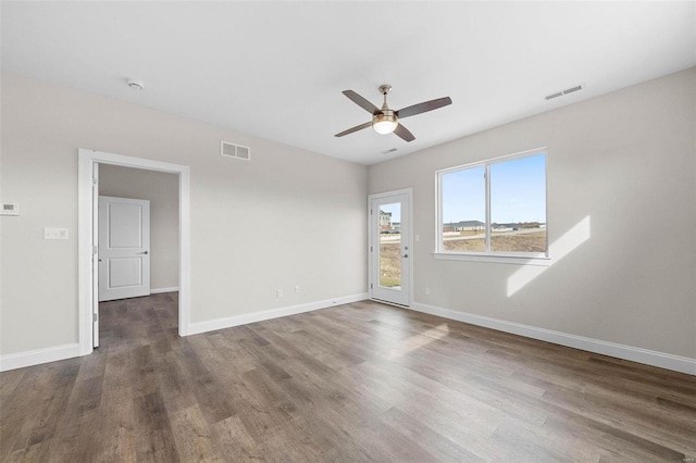 unfurnished room featuring wood finished floors, a ceiling fan, and baseboards