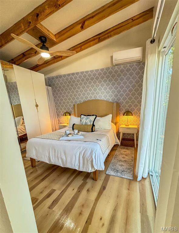 2510 N 89th St, Caseyville, IL 62232 - bedroom with a wall mounted air conditioner, light wood-style flooring, and beam ceiling