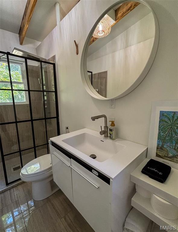 2510 N 89th St, Caseyville, IL 62232 - bathroom featuring toilet, vanity, a stall shower, and beam ceiling