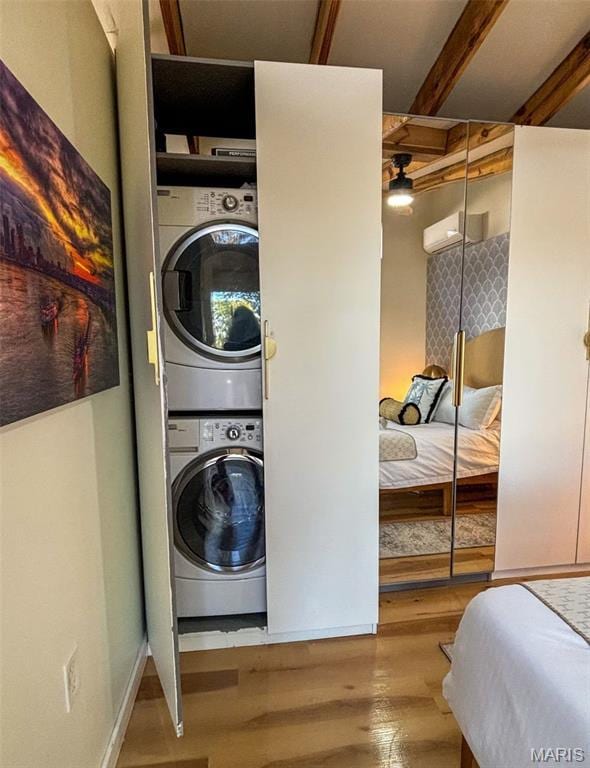 2510 N 89th St, Caseyville, IL 62232 - washroom with stacked washer and clothes dryer, wood finished floors, and a wall mounted air conditioner