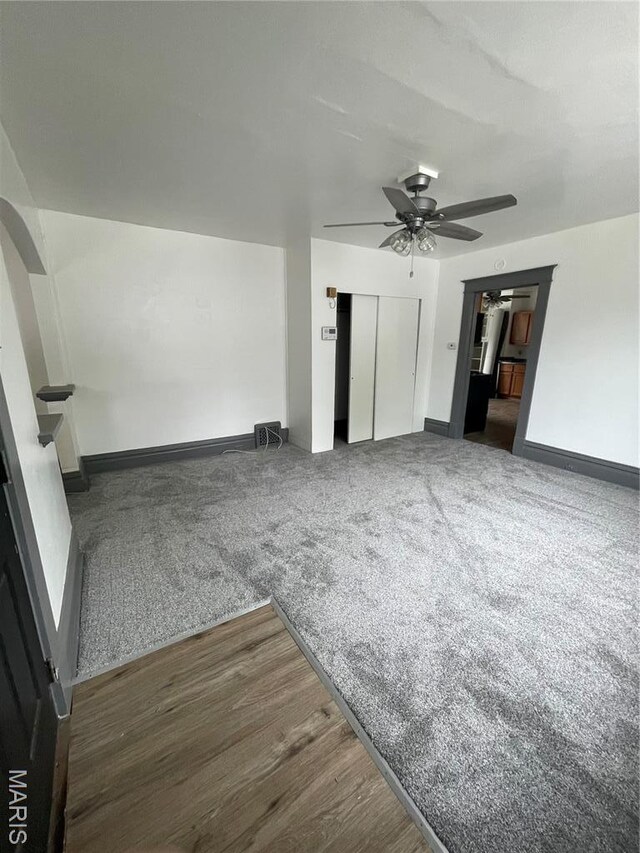 4947 Rosalie St, Saint Louis, MO 63115 - unfurnished living room with a ceiling fan, baseboards, and wood finished floors