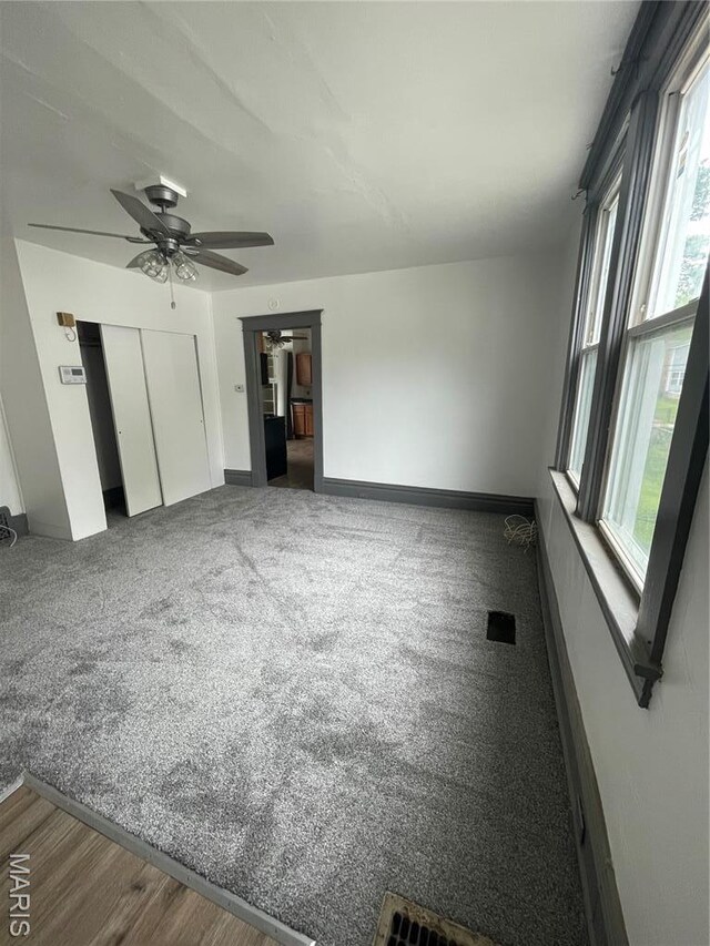 4947 Rosalie St, Saint Louis, MO 63115 - unfurnished living room with ceiling fan, carpet flooring, and baseboards