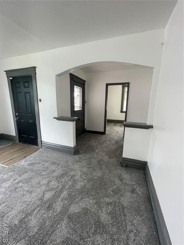 4947 Rosalie St, Saint Louis, MO 63115 - carpeted spare room featuring arched walkways and baseboards