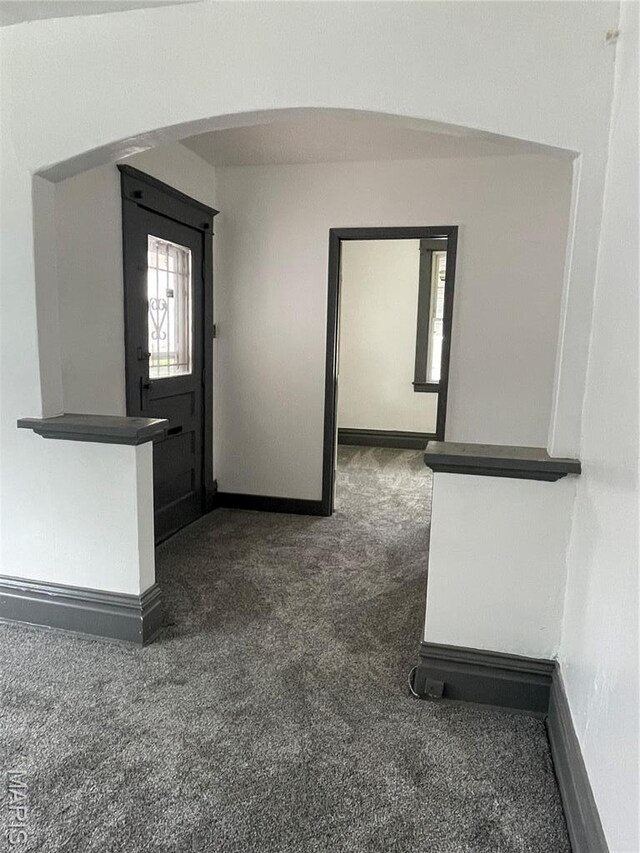 4947 Rosalie St, Saint Louis, MO 63115 - corridor with carpet floors, arched walkways, and baseboards