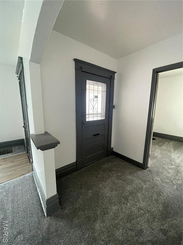 4947 Rosalie St, Saint Louis, MO 63115 - foyer entrance featuring dark colored carpet and baseboards