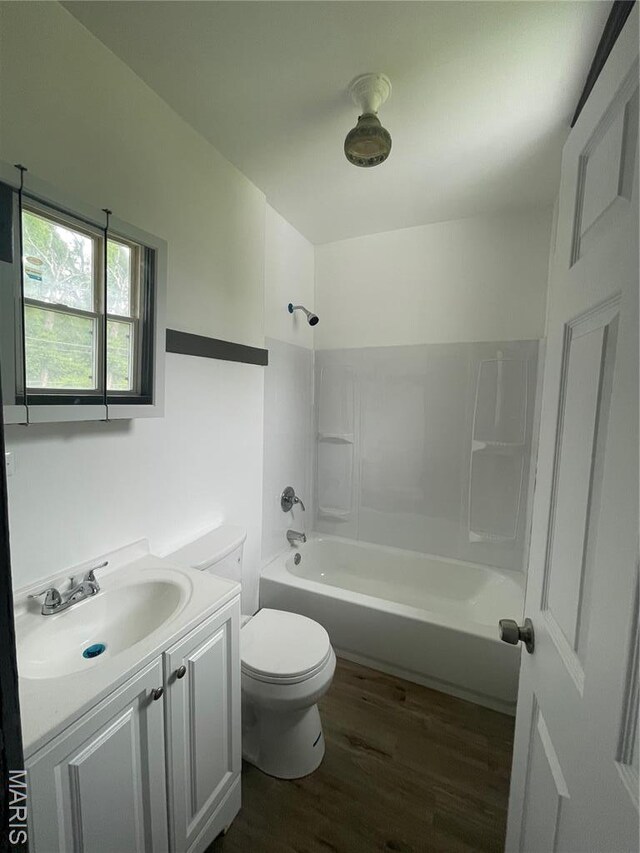 4947 Rosalie St, Saint Louis, MO 63115 - full bath featuring wood finished floors, toilet, vanity, and tub / shower combination