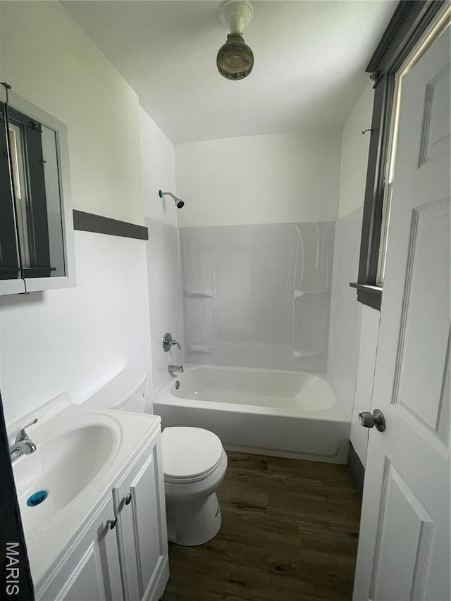 4947 Rosalie St, Saint Louis, MO 63115 - full bathroom featuring wood finished floors, toilet, bathtub / shower combination, and vanity
