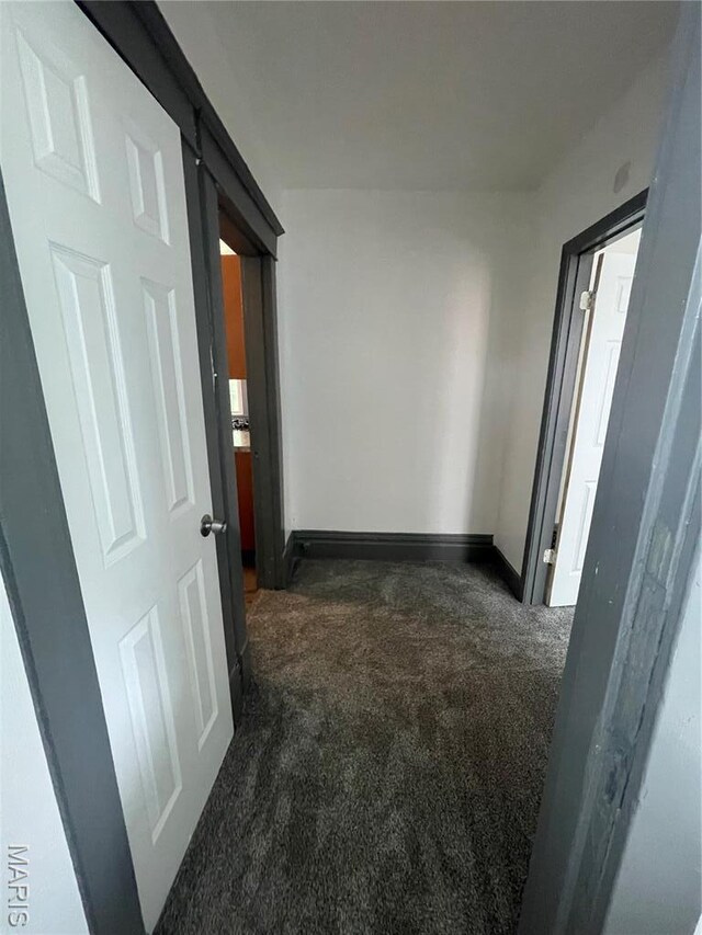 4947 Rosalie St, Saint Louis, MO 63115 - corridor featuring dark carpet and baseboards