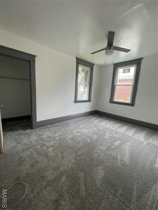 4947 Rosalie St, Saint Louis, MO 63115 - spare room featuring carpet, baseboards, plenty of natural light, and ceiling fan