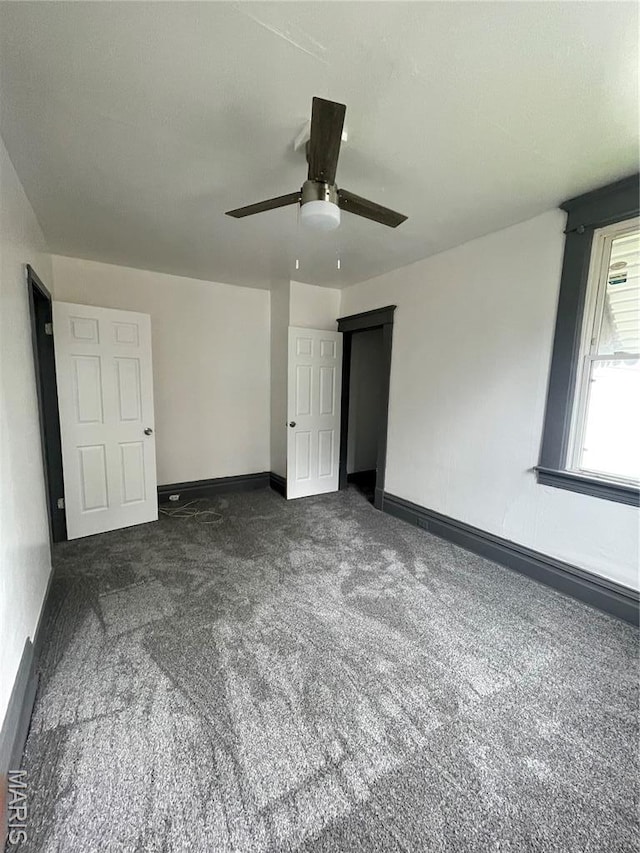 4947 Rosalie St, Saint Louis, MO 63115 - unfurnished bedroom featuring carpet, baseboards, and a ceiling fan