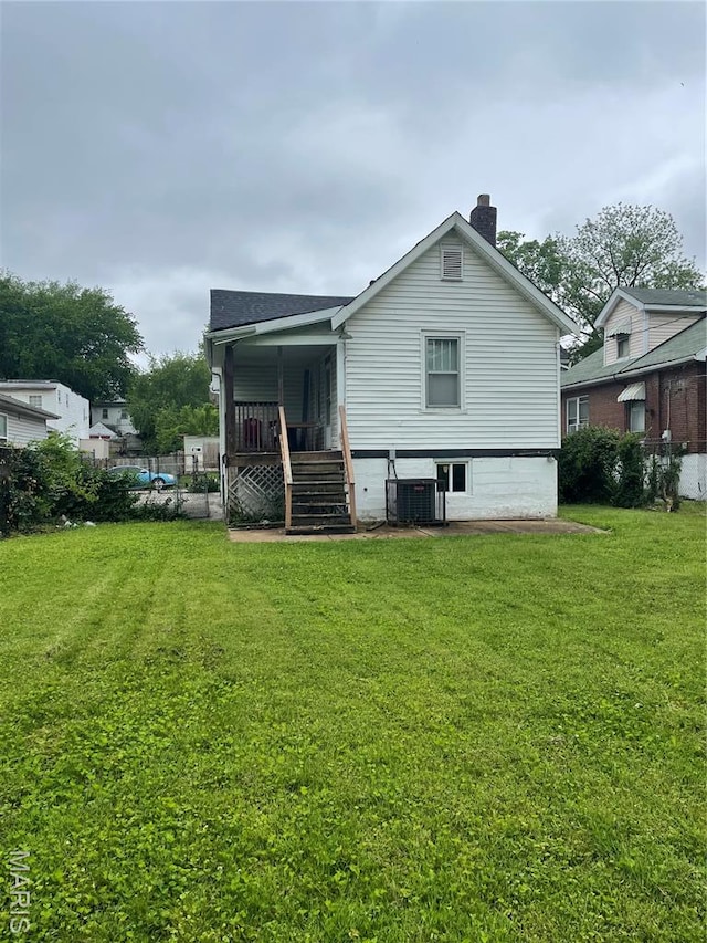 4947 Rosalie St, Saint Louis, MO 63115 - back of property with stairs, a yard, a chimney, and central AC