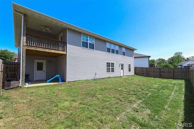 135 Mary Catherine, Waynesville, MO 65583 - back of house featuring a balcony, a fenced backyard, and a ceiling fan