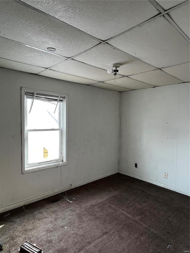 1642 3rd St, Madison, IL 62060 - empty room featuring dark carpet, a drop ceiling, and baseboards
