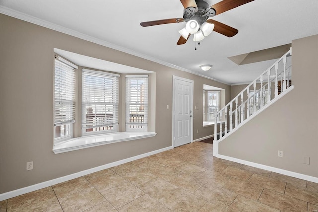 foyer with ornamental molding, stairway, baseboards, and ceiling fan