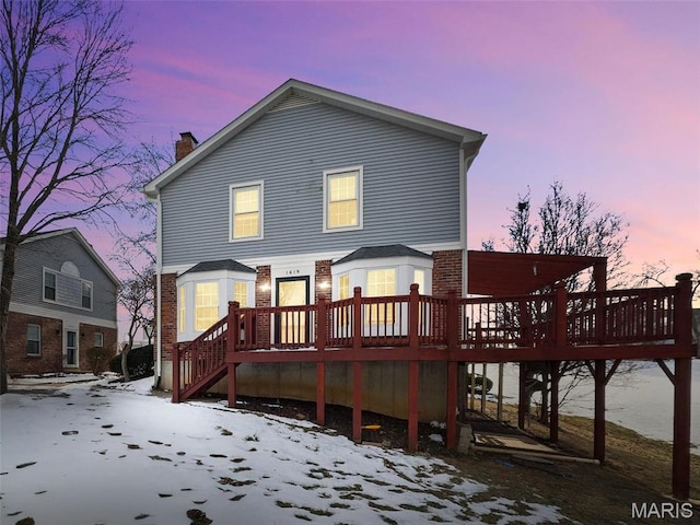 1619 Florine Boulevard E, Saint Charles, MO 63303 - snow covered house featuring brick siding, a deck, a chimney, and stairs