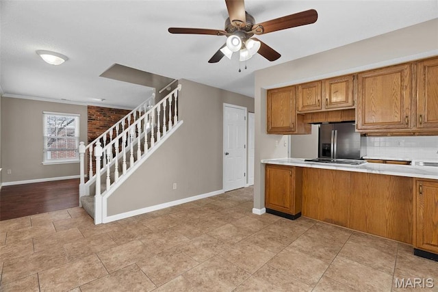 1619 Florine Boulevard E, Saint Charles, MO 63303 - kitchen featuring stainless steel refrigerator with ice dispenser, brown cabinets, ceiling fan, backsplash, and light countertops