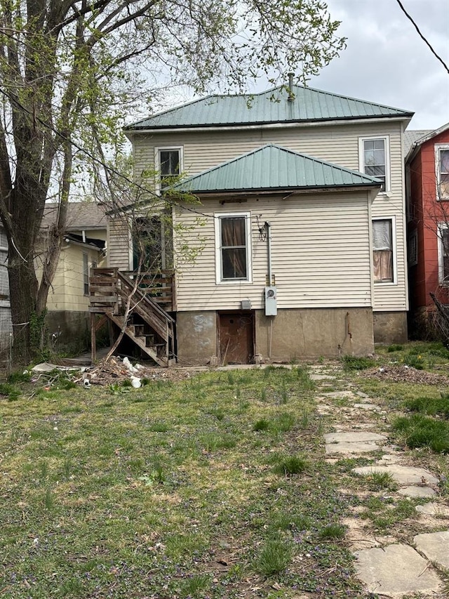 1809 Chestnut St, Hannibal, MO 63401 - rear view of house featuring stairs, a yard, and metal roof