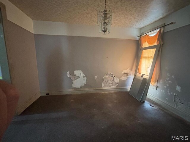 1809 Chestnut St, Hannibal, MO 63401 - unfurnished dining area featuring a textured ceiling and baseboards