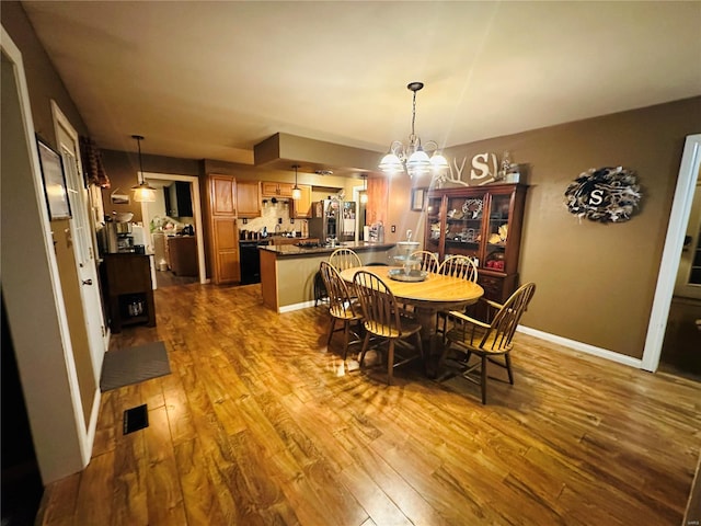 128 Pine St, Ironton, MO 63650 - dining area featuring dark wood-style floors and a chandelier