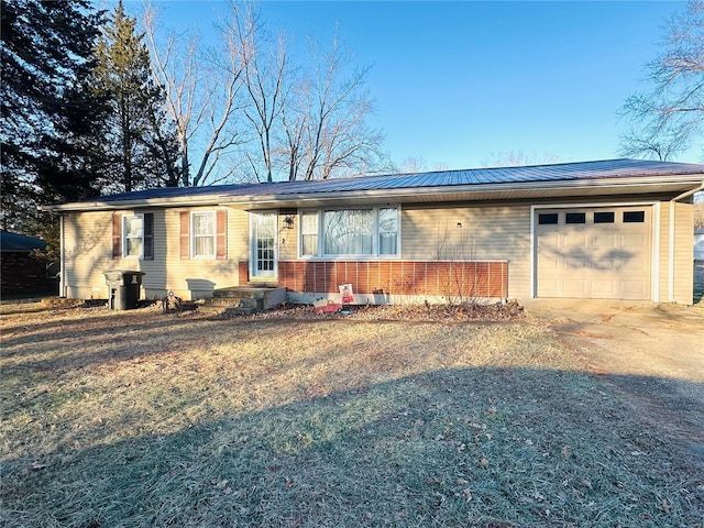 128 Pine St, Ironton, MO 63650 - single story home with an attached garage, concrete driveway, metal roof, and brick siding