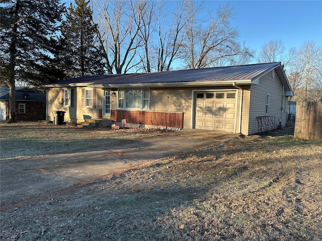 128 Pine St, Ironton, MO 63650 - ranch-style house with asphalt driveway, metal roof, an attached garage, and fence