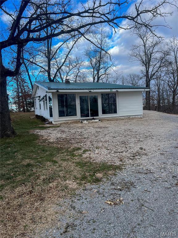13 Jo Ab Ln, Williamsville, MO 63967 - back of property featuring a metal roof and gravel driveway