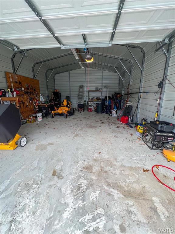 13 Jo Ab Ln, Williamsville, MO 63967 - garage with a garage door opener and metal wall