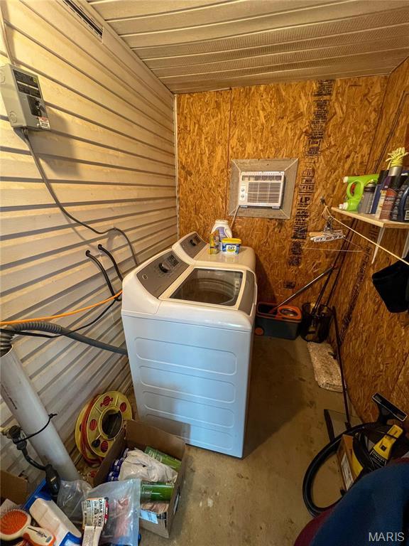 13 Jo Ab Ln, Williamsville, MO 63967 - washroom featuring wood walls, a wall unit AC, and washing machine and clothes dryer