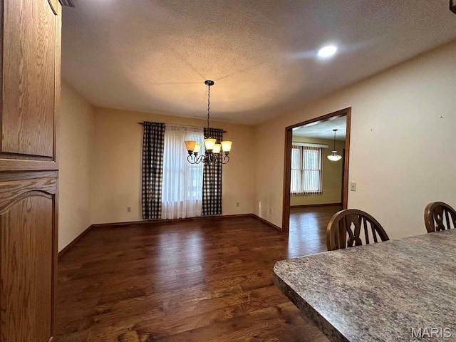 17264 Cedar Hills Dr, Dexter, MO 63841 - dining area featuring dark wood-style floors, a textured ceiling, a chandelier, and baseboards