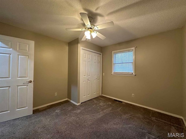 17264 Cedar Hills Dr, Dexter, MO 63841 - unfurnished bedroom with dark colored carpet, baseboards, a closet, a textured ceiling, and a ceiling fan