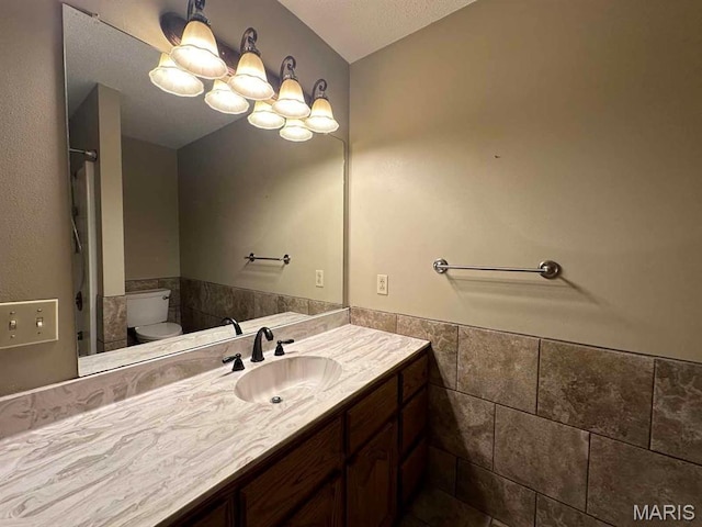 17264 Cedar Hills Dr, Dexter, MO 63841 - bathroom with toilet, vanity, tile walls, a wainscoted wall, and a shower