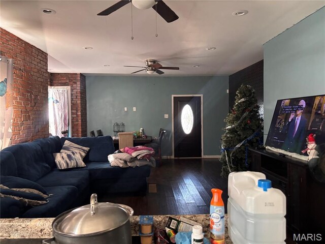 4600 Carrie Ave, Saint Louis, MO 63115 - living room featuring a ceiling fan, brick wall, hardwood / wood-style flooring, baseboards, and recessed lighting