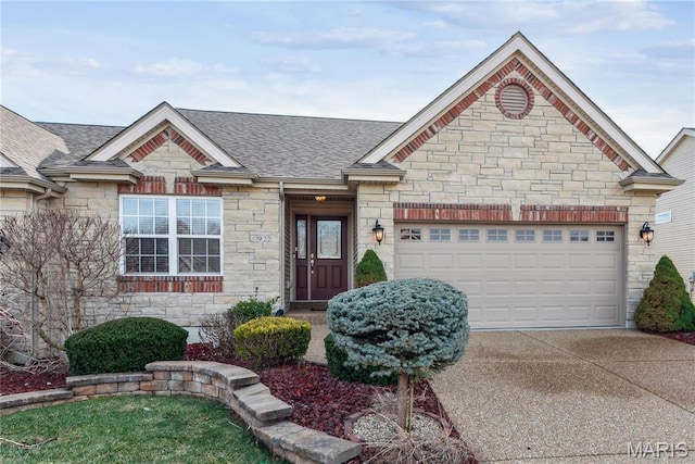 view of front of home with stone siding, roof with shingles, a garage, and driveway