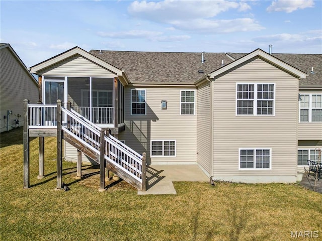 back of house with a sunroom, roof with shingles, a yard, and a patio area