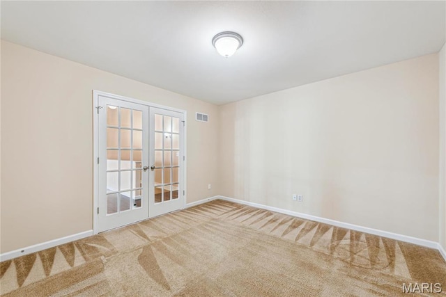 carpeted empty room with french doors and baseboards